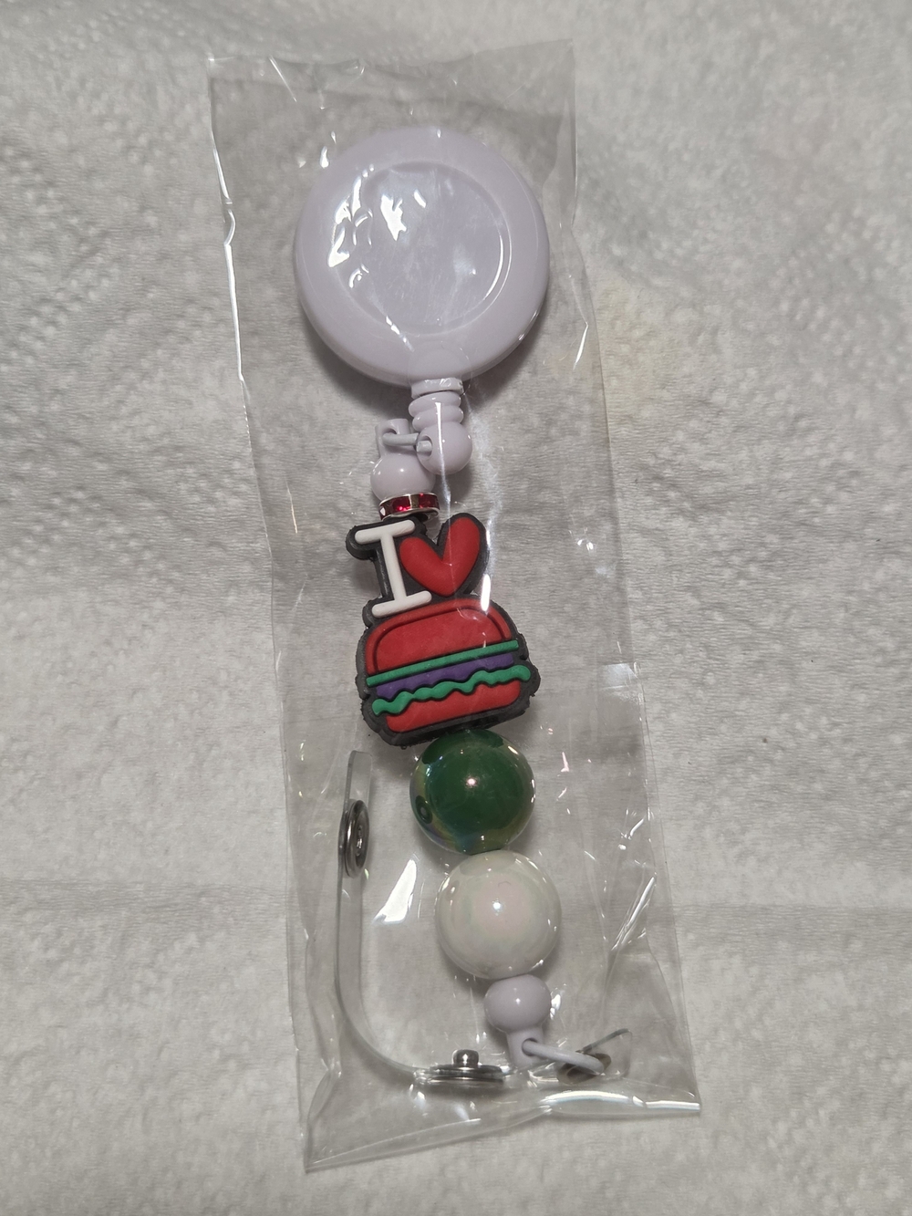 White Retractable Badge Reel with Red Burger Charm and Bead Accents
